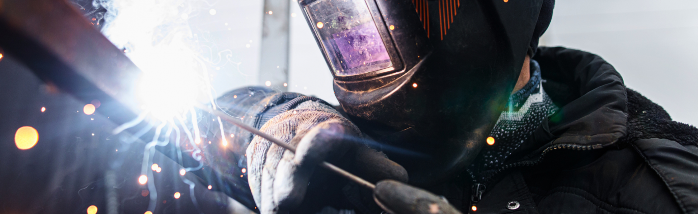 Thompson Repairs team fabricating a custom metal component in an industrial welding shop.